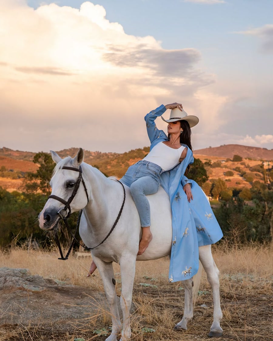 Editorial western glam on a white horse at golden hour